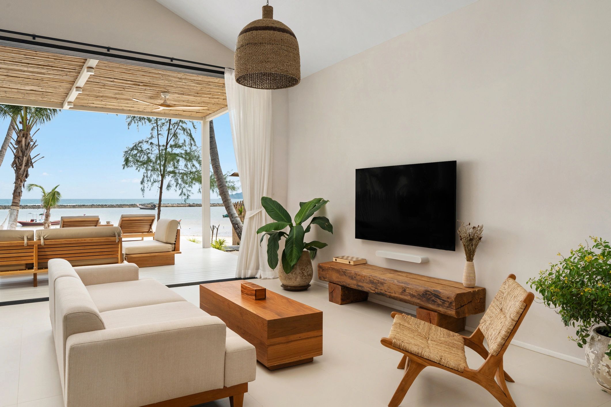 Cozy beachside living room with natural wood furniture and ocean view.